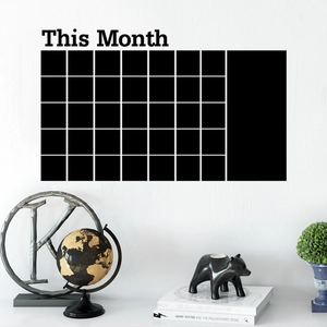 Macro view showing a matte black PVC monthly calendar wall sticker for office planning