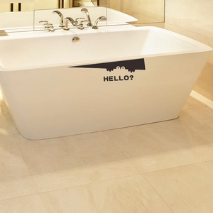 Funny monster peeking sticker with HELLO text on white bathtub side bathroom decor
