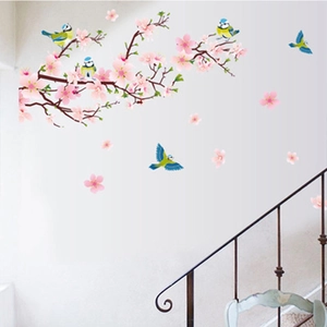 Close-up of pink cherry blossoms and blue birds wall decal applied to a staircase wall