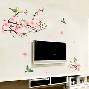 Detail view of pink peach blossom stickers and birds on a living room TV background wall