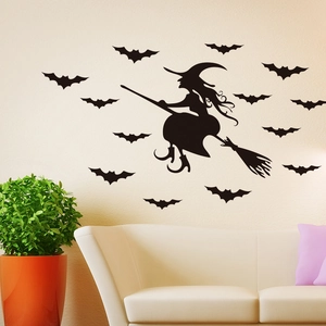Detail of Halloween witch on broom and bats silhouette wall stickers in a modern living room