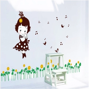 Detail view of cartoon girl and sunflower wall decals on a white bedroom wall