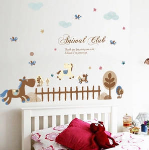 Detail view of Animal Club cartoon horse wall stickers applied on a nursery wall