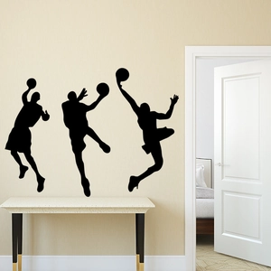 Three dynamic black silhouette basketball wall stickers showing players in action