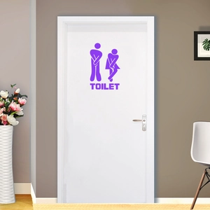 Purple vinyl sticker showing cartoon figures and TOILET text on a modern white door