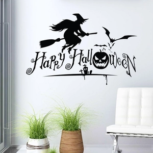 Halloween vinyl wall decal with witch, bats, and pumpkin displayed in a white room