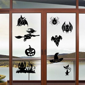 Close-up of black silhouette Halloween window stickers featuring bats and classic wizard motifs