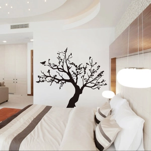 Detail view of black tree and birds silhouette wall decal on a bedroom background