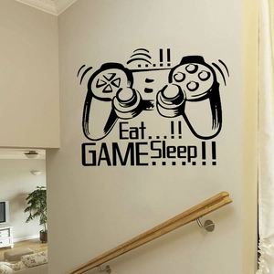 Detailed view of matte black game controller wall sticker on a home staircase wall