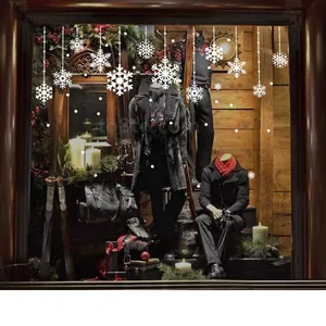 White snowflake window decals with Merry Christmas lettering on a shop glass display