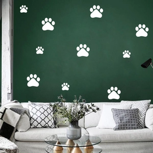Detailed white dog paw print wall stickers on a dark green living room wall background