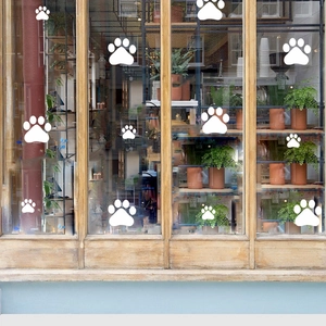 Minimalist white dog paw print wall stickers in various sizes for home window decor