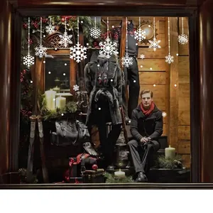 White snowflake stickers and Merry Christmas decals on shop window for holiday decoration