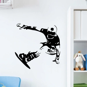 Black silhouette wall decal of a snowboarder jumping in the air for bedroom decor