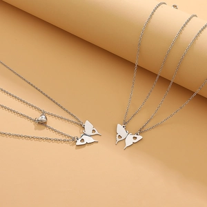Detail view of interlocking stainless steel butterfly pendant necklaces for best friends