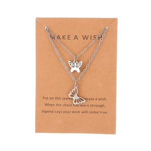 Double-layer stainless steel necklace featuring hollow butterfly pendants on a display card