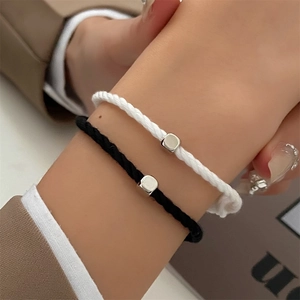 Handmade woven couple bracelets with polished square metal pendants in black and white