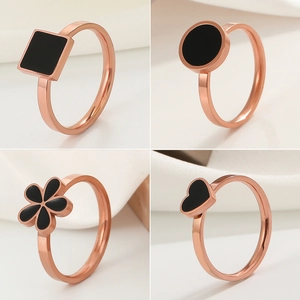 Polished rose gold stainless steel rings with black enamel heart and floral shapes