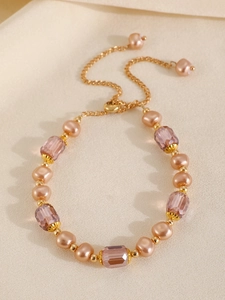 Detail of baroque pearl and lavender crystal bracelet with golden adjustable chain link