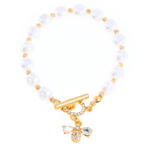 Detailed macro view of baroque pearl bracelet with gold bee charm and rhinestone OT clasp