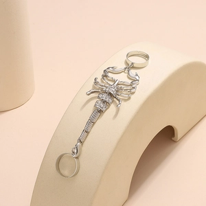 Detailed view of silver scorpion finger ring with crystal pavé and articulated punk joints