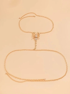 Detailed view of a golden scorpion hand chain with sparkling zircon crystal accents