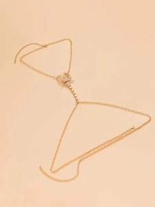 Detailed close-up of a gold scorpion thigh chain with sparkling inlaid rhinestones