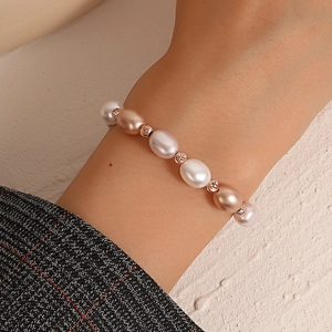 Minimalist baroque pearl bracelet with colorful pearls and rose gold beads on wrist