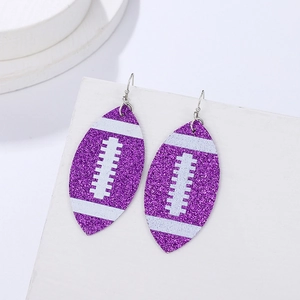 Detailed view of handmade purple glitter rugby earrings with white stitching detail