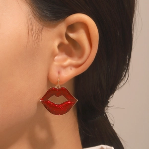 Exaggerated red lip heart drop earrings with glitter finish on a female model