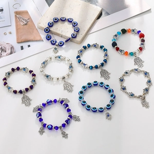 Bohemian Evil Eye and Hamsa Hand beaded bracelet with blue glass beads and silver charms
