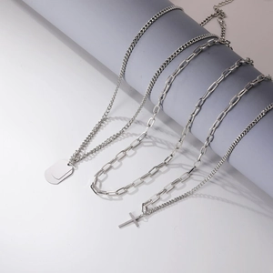 Detail view of multi-layered silver chains with cross and military tag pendants