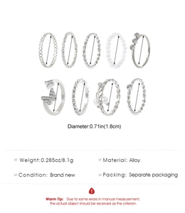 Detail view of 9-piece silver alloy ring set with butterfly zircon and pearl accents