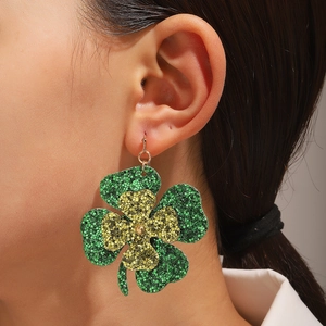 Saint Patrick's Day glittery green clover earrings for women shown on model