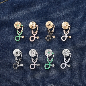 Colorful stethoscope enamel pins for doctors in gold and silver finish on denim fabric