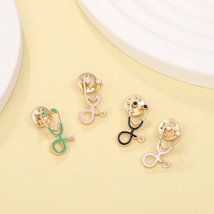Detailed view of four colorful stethoscope enamel pins with gold finish and drip oil gloss