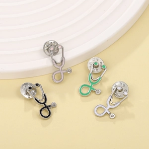 Detail of colorful stethoscope enamel pins in pink, green, black, and white colors