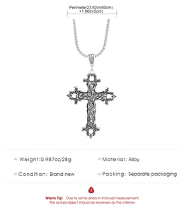 Detail view of retro alloy cross pendant with embossed floral patterns on silver chain
