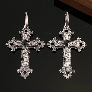 Gothic silver cross pendant featuring intricate floral filigree and a black gemstone