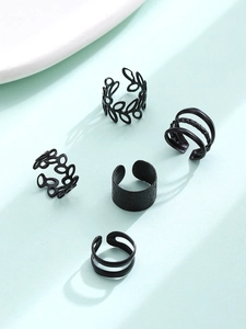 Detail showing five-piece set of vintage matte black C-shaped ear clips and hollow leaf rings