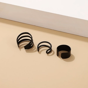 Detail of three black C-shaped ear cuffs set for non-pierced ears in minimalist style