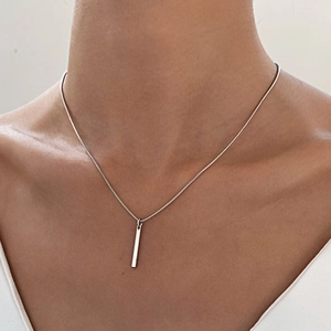 Men's minimalist silver geometric bar pendant necklace on a snake chain shown on model