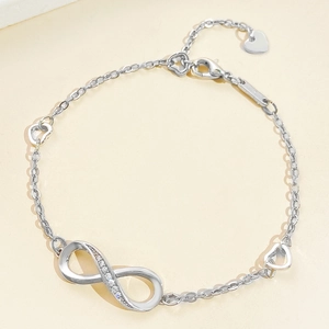 Silver infinity bracelet with pavé cubic zirconia and heart charms for women