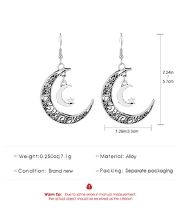 Detailed view of silver star and moon drop earrings with specific size dimensions