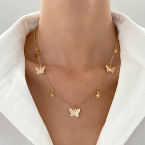 Minimalist gold butterfly and star pendant necklace worn on a female neck for elegant style