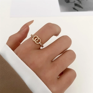 Macro shot of gold double interlocking ring with pavé zircons worn on model finger