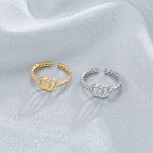 Fashionable gold and silver double ring with sparkling zircon inlays on fabric