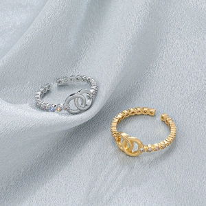 Detailed macro view of gold and silver interlocking rings with paved cubic zirconia