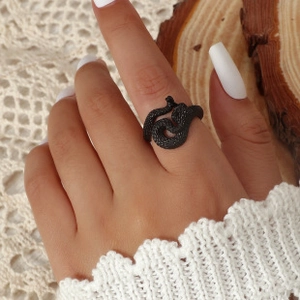 Detail view of vintage matte black snake ring with scales texture on finger