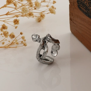 Close-up of vintage silver snake ring featuring realistic scale textures and wrap design